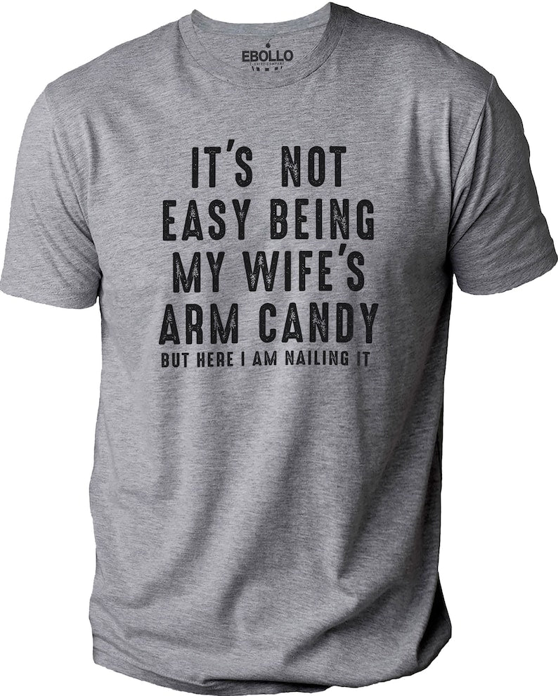 Its Not Easy Being My Wifes Arm Candy  Funny Shirt Men   Fathers Day Gift   Husband Shirt   Dad Gift   Gift For Husband   Funny Dad Tee 1712309371894.jpg