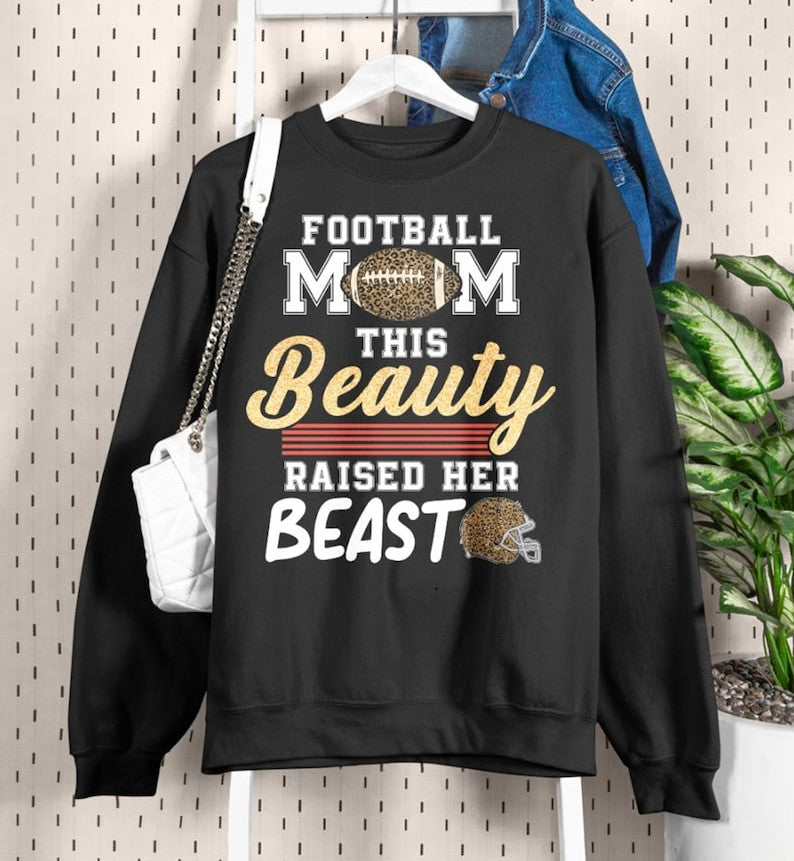 This Beauty Raised Her Beast Football Mom Shirt Funny Football Sayings Shirt 1713757561405.jpg