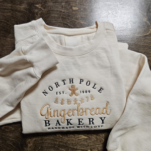 north pole gingerbread bakery handmade with love embroidered sweatshirt 1728371583439.png