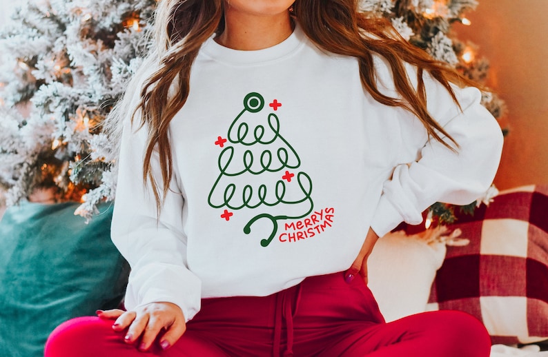 merry christmas stethoscope sweatshirt christmas crewneck cna gift christmas gift nurse holidays gift xmas shirt for medical worker 1730450504382.jpg