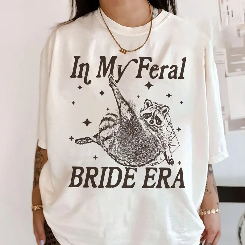 In My Feral Bride Era Shirt, Funny Raccoon, Funny Bride Shirt, Gift For Bride To Be, Engagement Gift, Wedding Planning, Bridal Meme Shirt da406215-bbd5-4cee-a0a5-47b0e1d80bd6-dgfdfrewtyjhj-5-.webp