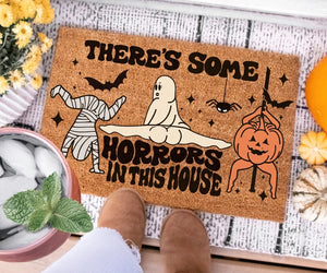 There's Some Horrors In This House Doormat, Funny Ghost Pumpkin Door Mat, Halloween Welcome Mat, Spooky Season Halloween Front Door Mat f98d9cd9-aa75-4fb6-baba-a0cdcc8568a5-rtertderg-1-.webp