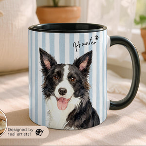 Mug with a dog illustration on a striped background, placed on a surface with plants in the background.
